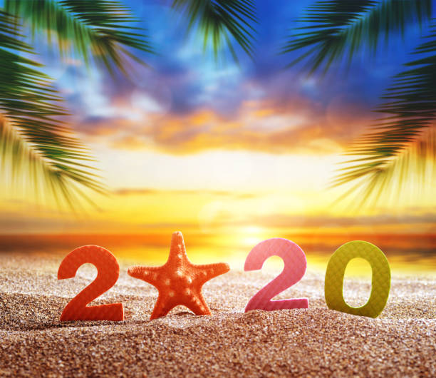 istock Number 2020 and starfish on the sand beach. 1195006661