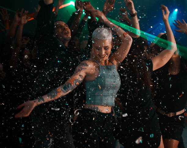 Cropped shot of an attractive young woman dancing while partying with her friends in a club at night