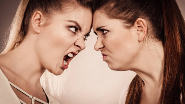 istock Two agressive women having argue fight 1195012056