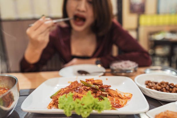 istock Young asian woman eating dinner in restaurant 1195012216