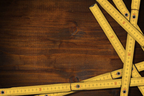 yellow folding wooden rulers on a work table with copy space - folding ruler imagens e fotografias de stock