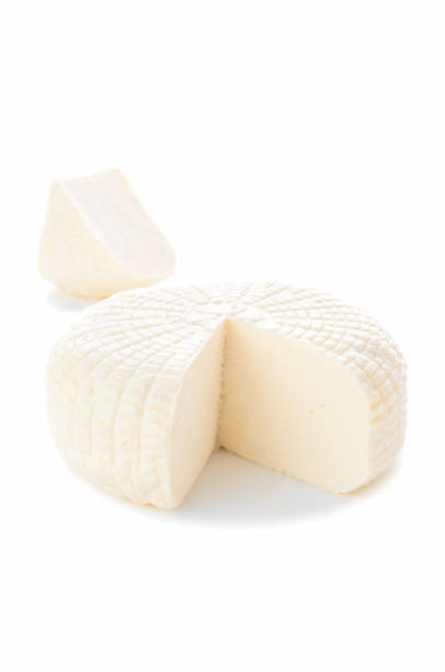 istock Sulguni cheese. A piece of triangular shape is cut out. A piece in the background. Isolated on a white background. 1195014555