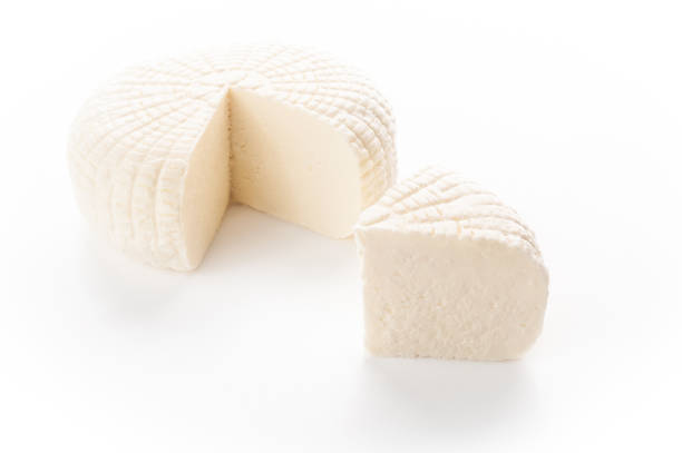 istock Sulguni cheese. A piece of triangular shape is cut out. Isolated on a white background. 1195015021
