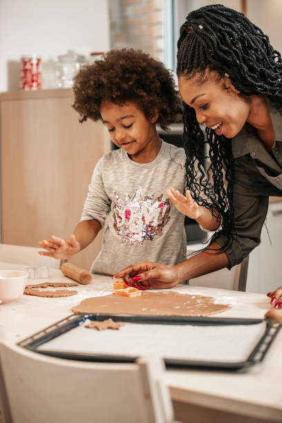 istock Girl Making Gingerbread Cookies With Mom 1195016274