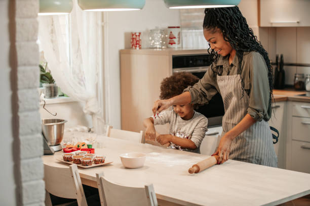 istock Girl Making Gingerbread Cookies With Mom 1195016394