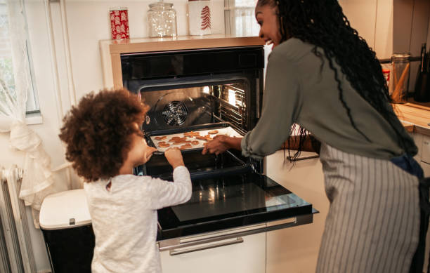 istock Girl Making Gingerbread Cookies With Mom 1195016565