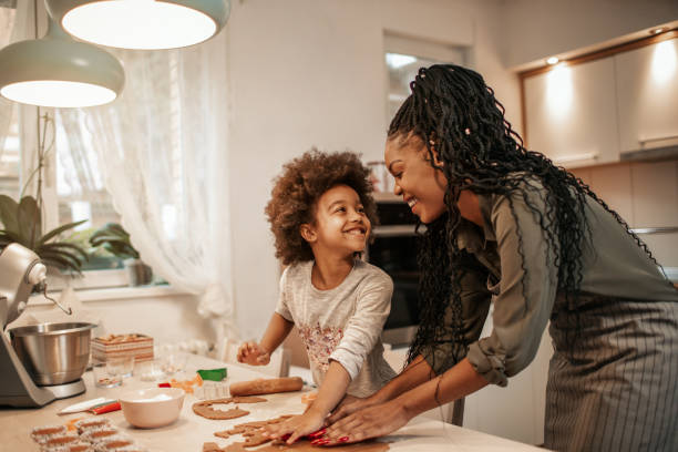 Girl Making Gingerbread Cookies With Mom