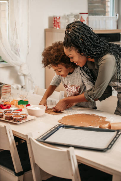 istock Girl Making Gingerbread Cookies With Mom 1195016667