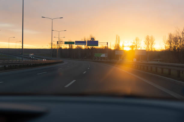 istock Sunrise on the road from the car window. 1195016797