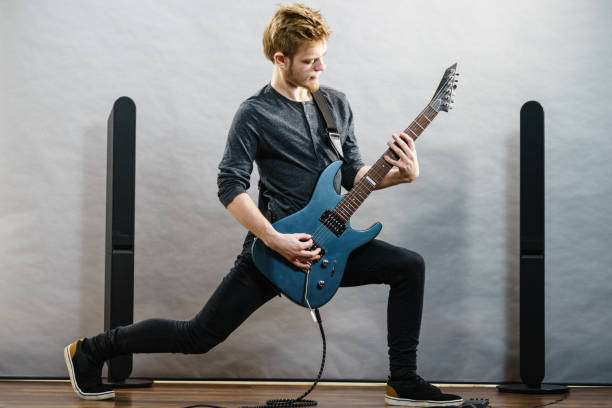 istock Young man playing electric guitar 1195017703