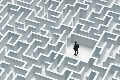 Solution concept with a Businessman at the center of labyrinth, Digitally Generated Image.