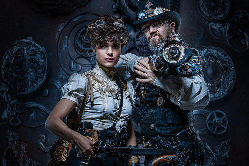 Steampunk couple of male and female enthusiasts in a studio shot