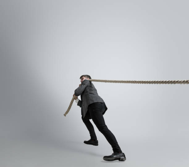 istock Caucasian man in office clothes training isolated on grey studio background 1195021372