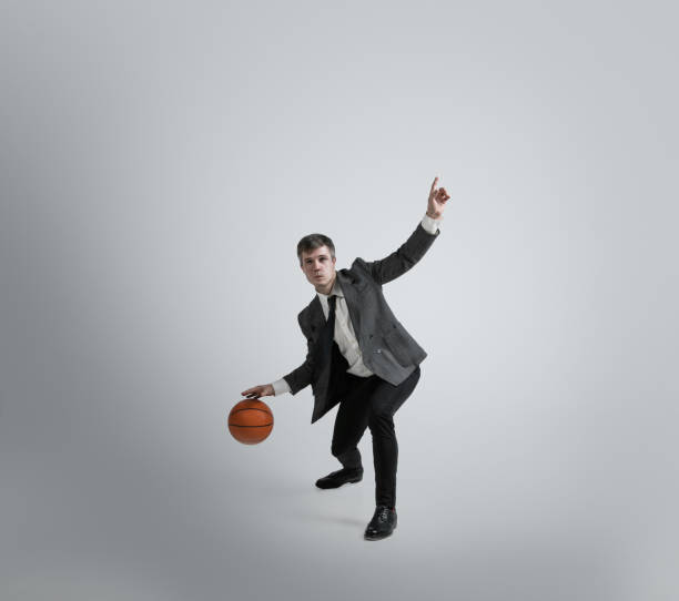 istock Caucasian man in office clothes training isolated on grey studio background 1195021407