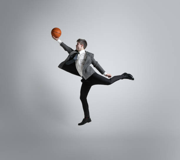 istock Caucasian man in office clothes training isolated on grey studio background 1195021408