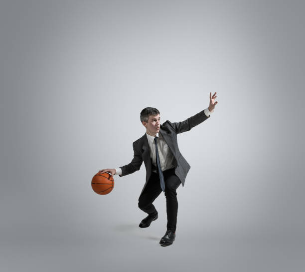 istock Caucasian man in office clothes training isolated on grey studio background 1195021411