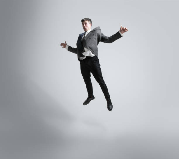 istock Caucasian man in office clothes training isolated on grey studio background 1195021460