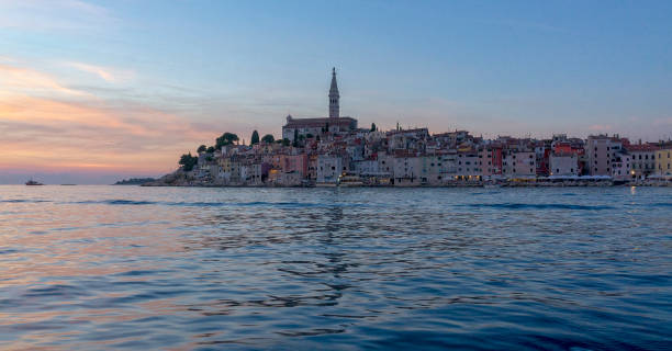 Sunset over an old town of Rovinj, Istria, Croatia View of the historical city centre of Rovinj with sunset, Adriatic sea, Istria, Croatia. rovinj harbor stock pictures, royalty-free photos & images