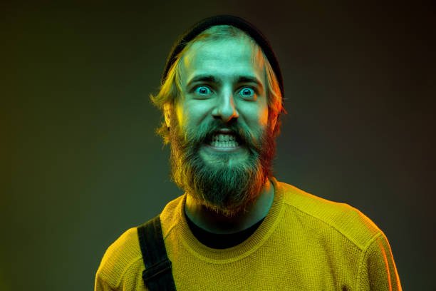 istock Caucasian man's portrait isolated on gradient studio background in neon light 1195025926