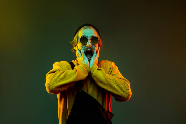 istock Caucasian man's portrait isolated on gradient studio background in neon light 1195025944