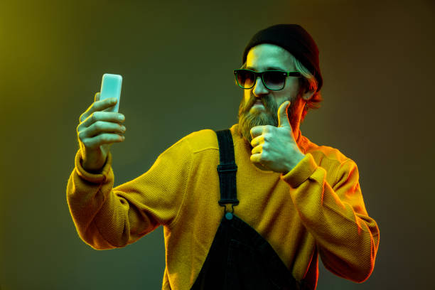 istock Caucasian man's portrait isolated on gradient studio background in neon light 1195026009