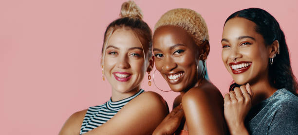 Too much prettiness in one picture Studio portrait of a diverse group of beautiful young women smiling while standing against a pink background too thin stock pictures, royalty-free photos & images
