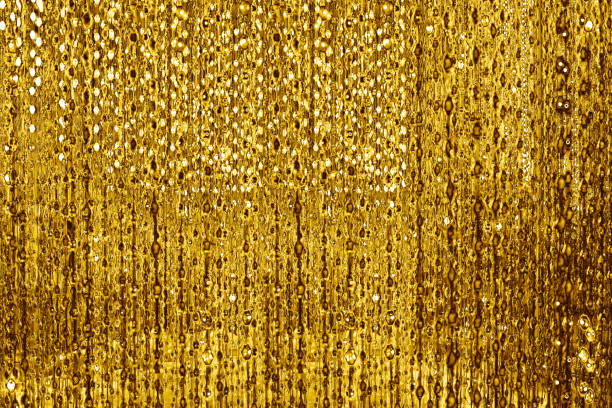 istock Abstract shiny golden lines and bubbles backdrop, blurred bokeh background, glowing gold colored decorative stripes pattern, yellow metallic glitter texture, holidays design, festive frame, copy space 1195027246