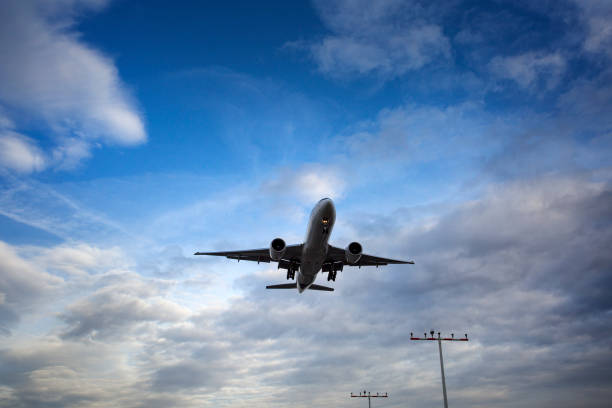 istock Low-angle view of a landing airplane 1195028488