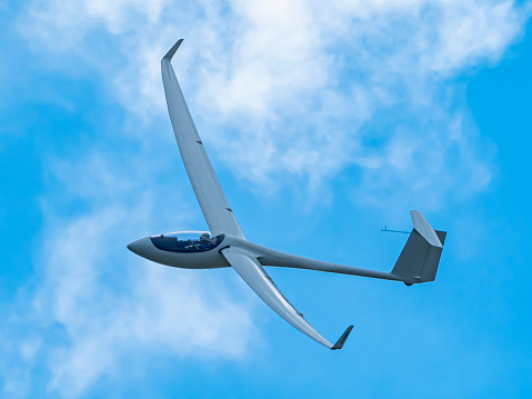 Glider plane flying in the clouds