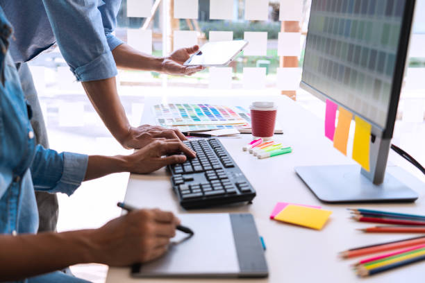 istock Midsection Of Design Professionals Working While Sitting At Office Desk 1195033906