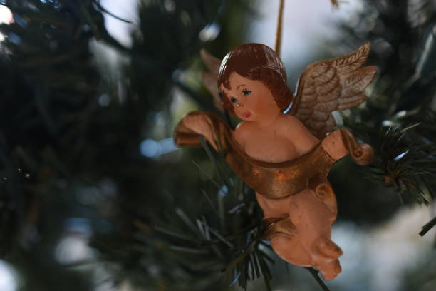 istock Angel Figurine Hanging On Christmas Tree 1195034009