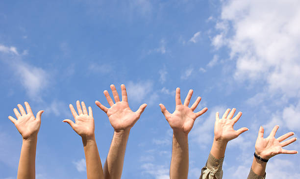 istock Hands rised up in air across  sky 119503837