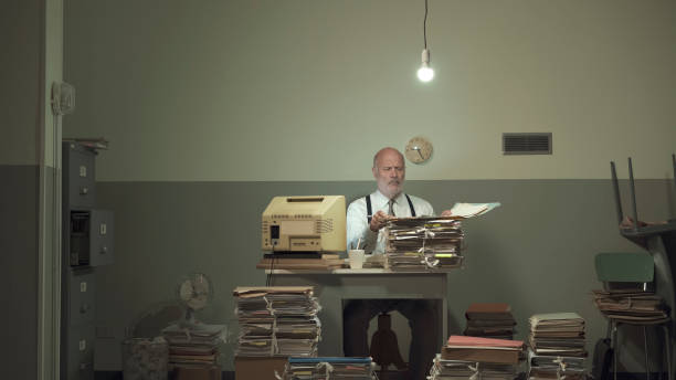 istock Frustrated businessman overloaded with paperwork 1195045397