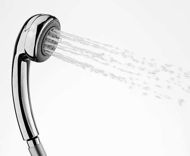 Silver shower head with water coming out of it stock photo