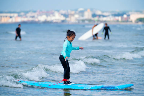 istock Six year old girl surfing 1195045801