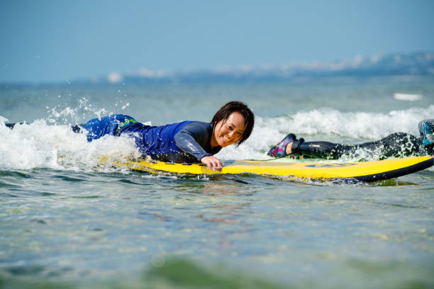 istock Mature woman taking a surfing lesson 1195045898