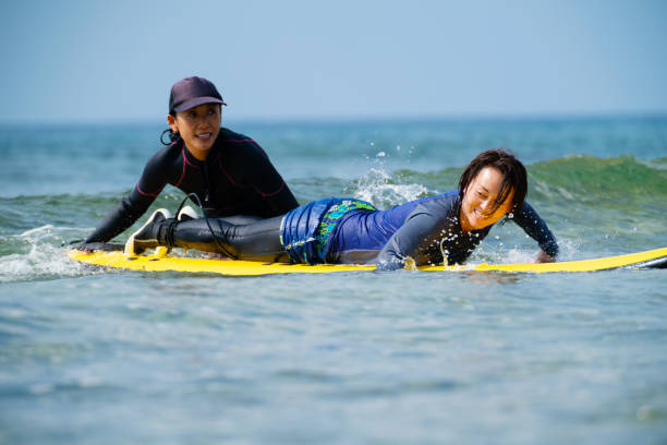 istock Mature woman taking a surfing lesson 1195045939