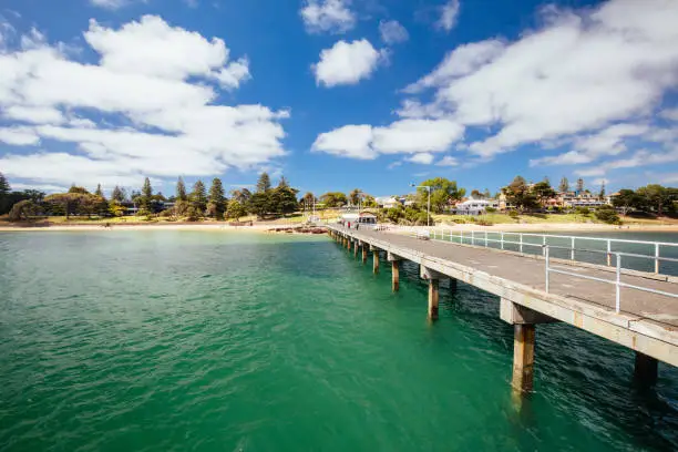 Cowes Foreshore and its iconic jetty and beach on a warm summer's day in Philip Island, Australia