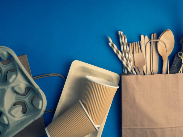 istock Eco friendly bamboo cutlery set on blue background. Various kraft paper packaging, containers for takeaway food, drinks. Zero waste and recycling concept. 1195049615