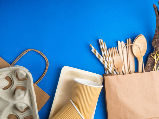 istock Eco friendly bamboo cutlery set on blue background. Various kraft paper packaging, containers for takeaway food, drinks. Zero waste and recycling concept. 1195049691
