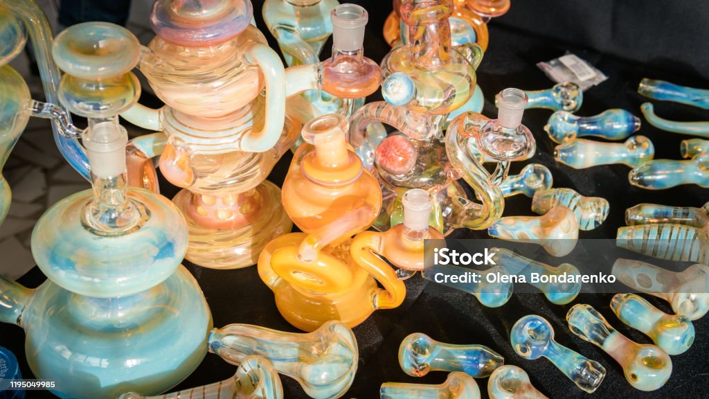 Accessories for smoking marijuana in the store, close-up. Accessories for smoking marijuana in the store, close-up. Glass bongs and smoking pipes. Design accessories Bong Stock Photo