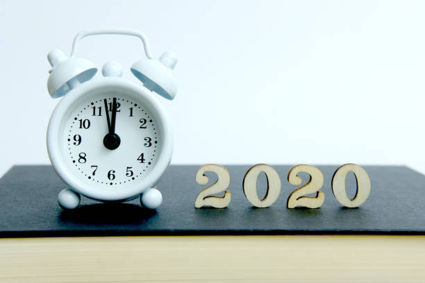 istock 2020 wooden number with clock and book on a table 1195051167