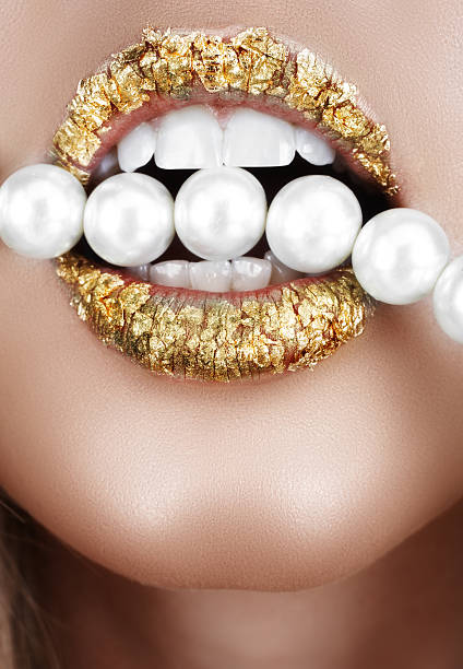 gold lips with pearls stock photo