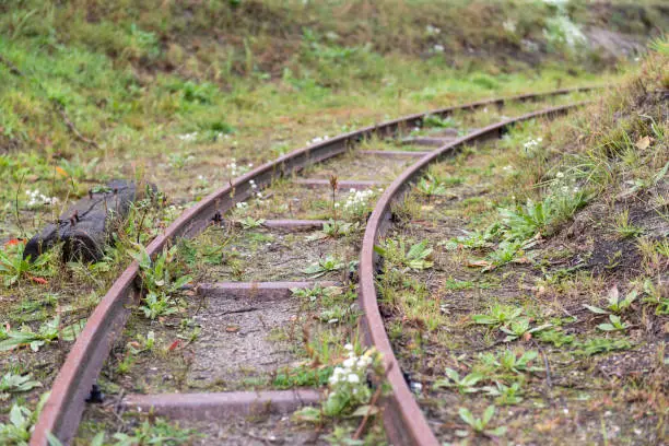 A disused historic narrow gauge railway with a right turn deflecting