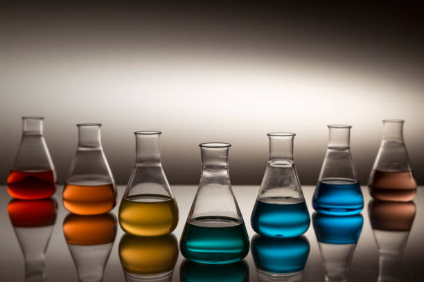istock Scientific laboratory glass erlenmeyer flask filled with colorful liquid forming rainbow. 1195055240