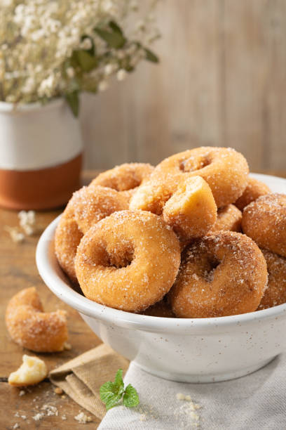 istock Typical spanish donuts, fried rosquillas with sugar for breakfast on rustic wooden table, traditional homemade anise donuts from Spain, typically eaten in Easter, copy space. 1195059069