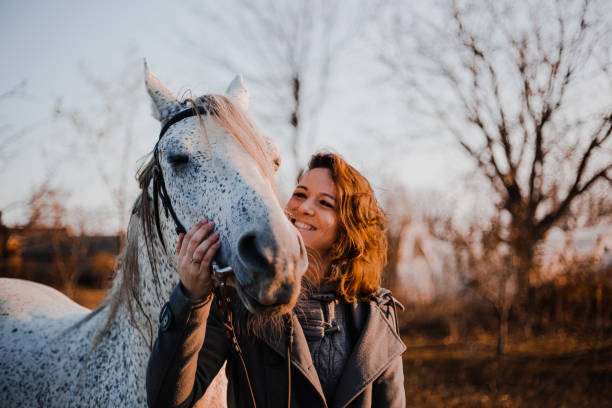 istock Women with horse 1195063170
