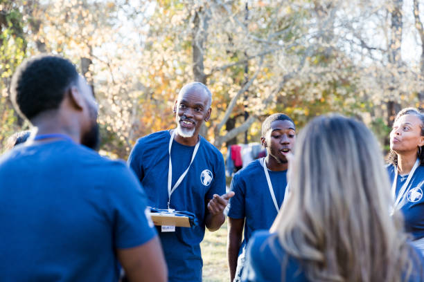 istock Diverse volunteers smile and laugh before staring cleanup 1195063215