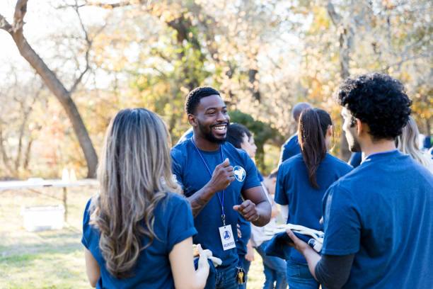 Volunteers at community event stand in small groups and talk