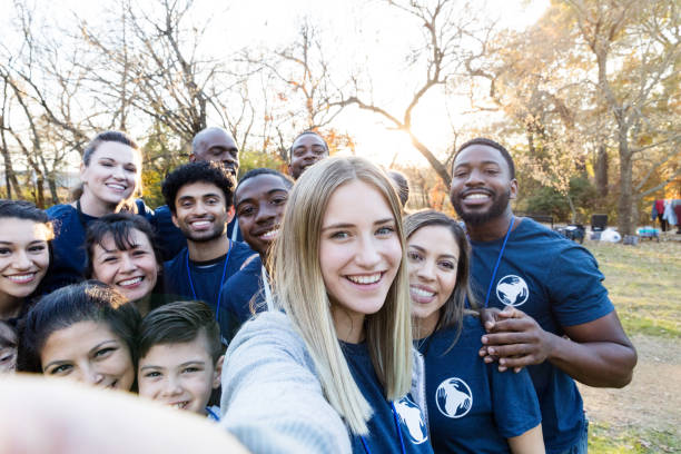 istock Diverse group of volunteers crowds together for selfie 1195063281